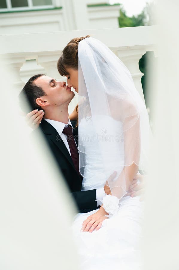 Groom embracing bride and kiss nose. Love couple