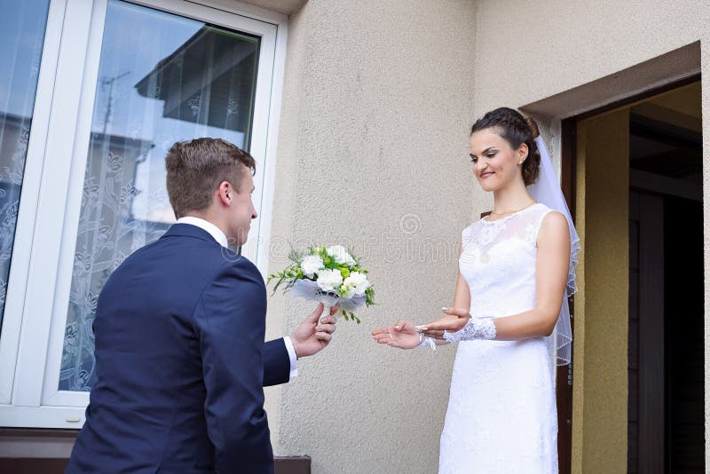 The Groom Gives the Bride Flowers Stock Photo Image of love, beauty