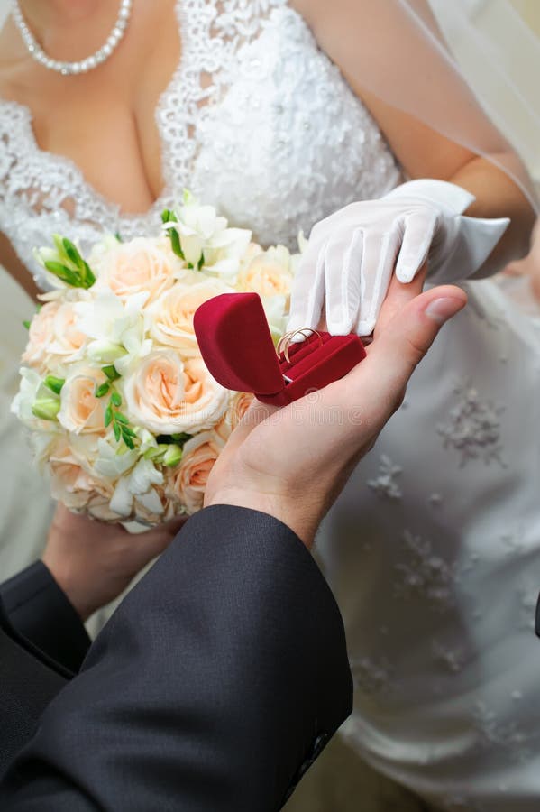 Groom gives to bride a gold ring