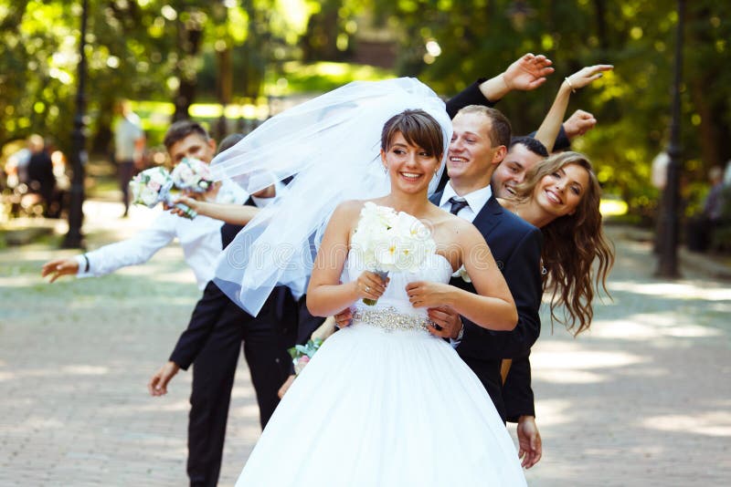 Groom looks funny while friends dance behind her stock photography Groom looks funny while friends dance behind her stock photography