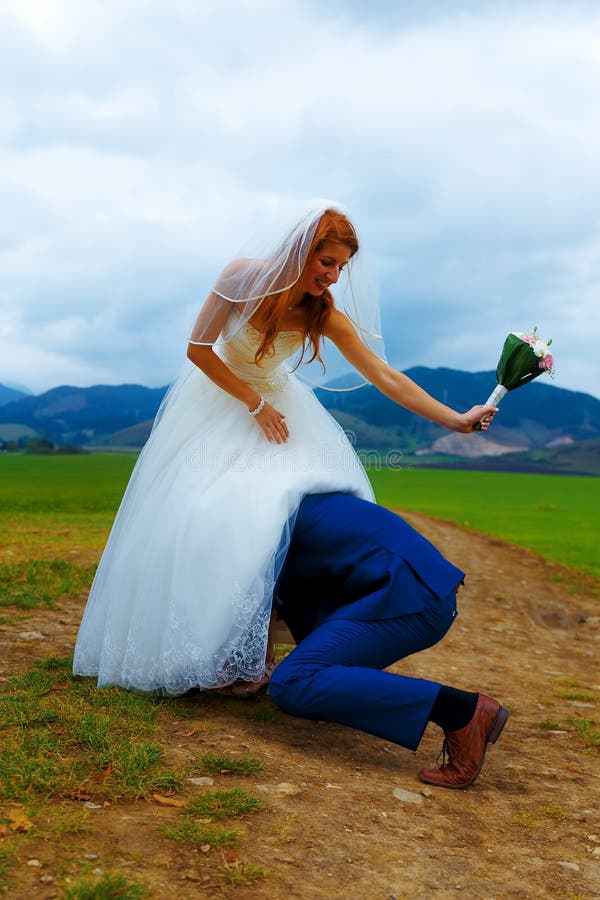 Groom Peeking Under His Bride Dress ...