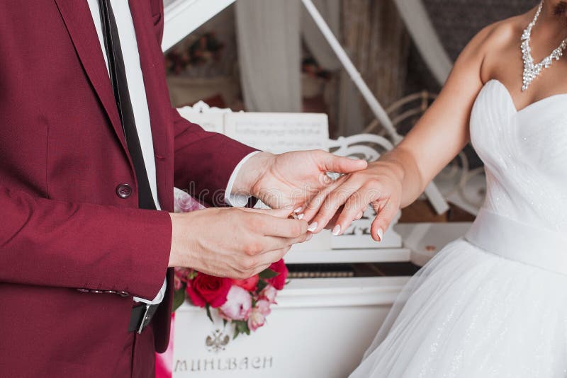 Groom Placing a Wedding Ring on the Finger of His Bride during Ceremony