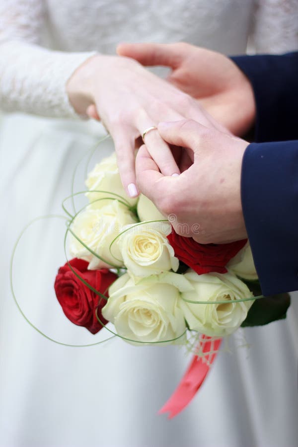 Groom Put on a Ring To Bride`s Finger during Wedding Ceremony. Stock