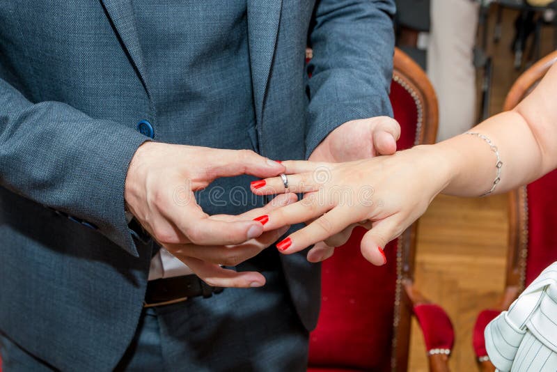 Groom Puts Wedding Ring on Bride`s Finger Stock Photo Image of close