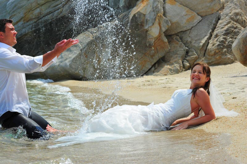 Groom Splashing Bride with Sea Water Drops Stock Image - Image of ...