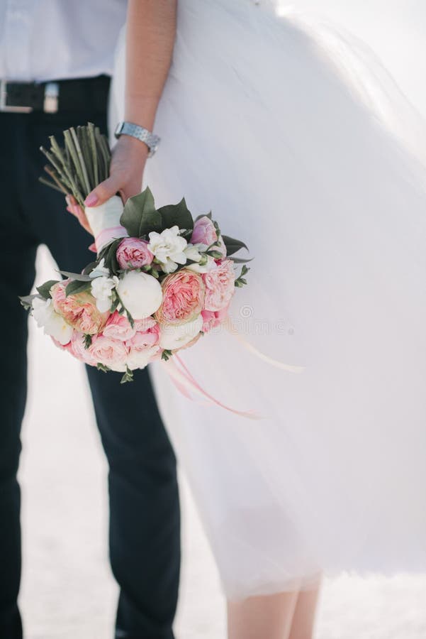 The groom in a suit hugs the bride in a wedding dress stock photos The groom in a suit hugs the bride in a wedding dress stock photos