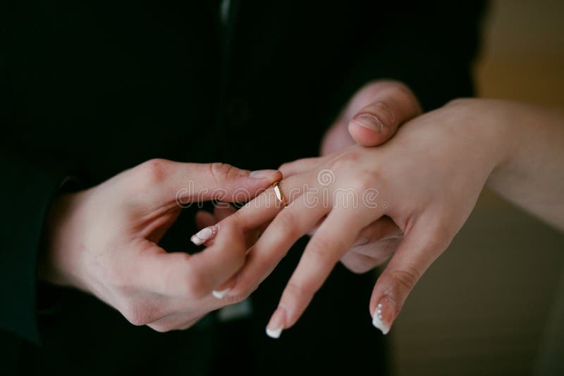 Groom Wearing the Wedding Ring on Bride. he Put the Ring on Her Stock