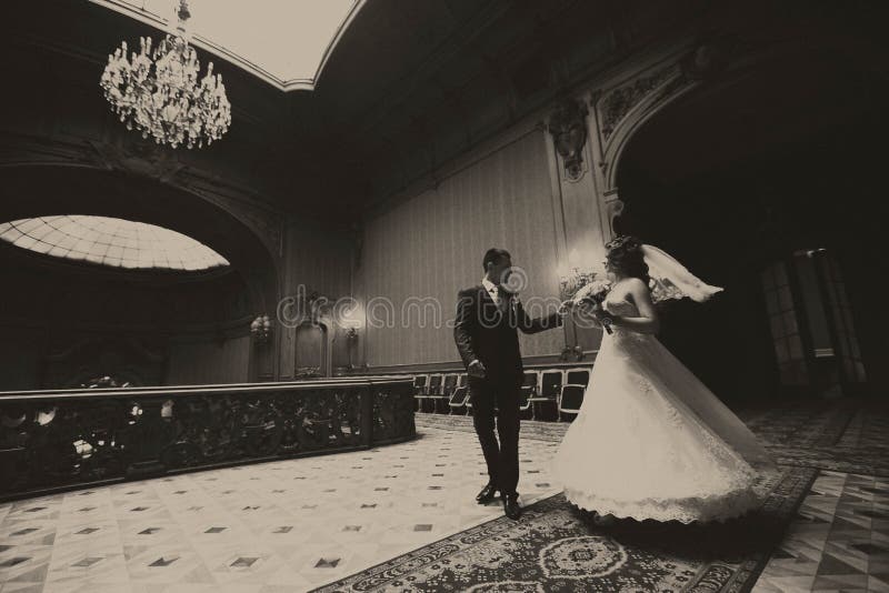 Groom whirls a bride in the centre of old hall royalty free stock image Groom whirls a bride in the centre of old hall royalty free stock image