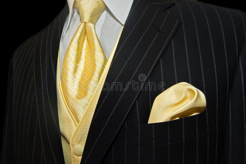 Gold tie and vest with handkerchief accenting a pinstripe tuxedo. Gold tie and vest with handkerchief accenting a pinstripe tuxedo.