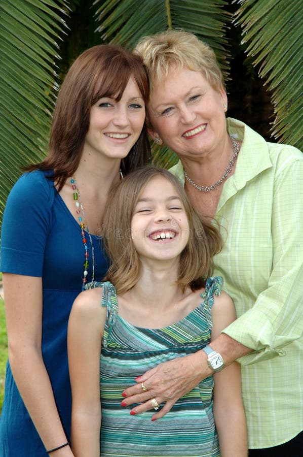 The faces of a grandmother and her grandaughters. The faces of a grandmother and her grandaughters