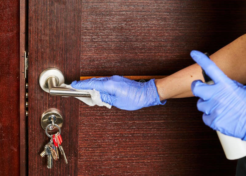 Close-up of disinfection, cleaning and washing of door handles in white gloves. Coronavirus infection prevention. Close-up of disinfection, cleaning and washing of door handles in white gloves. Coronavirus infection prevention.