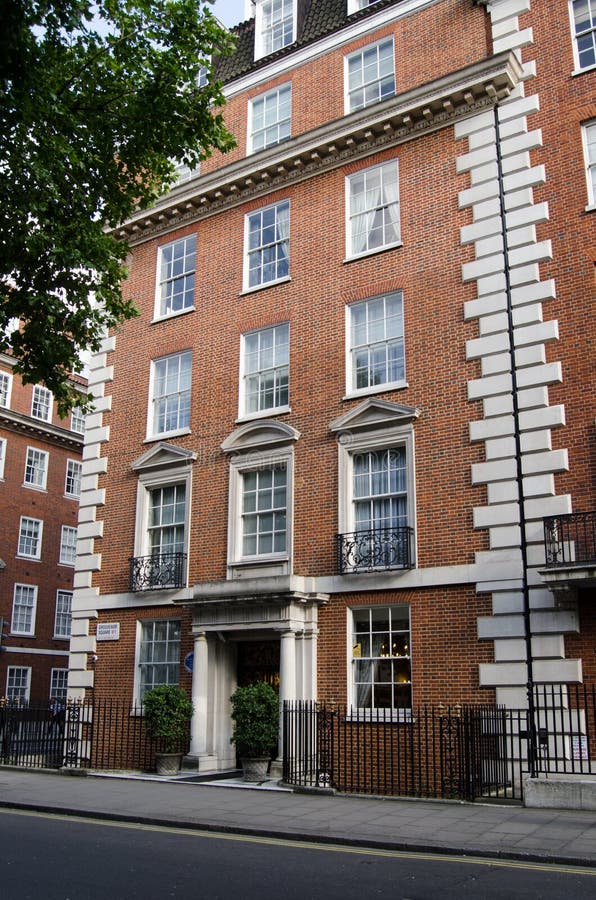 LONDON, UK - JULY 25, 2017: Exterior of the one time home of the architect Charles Edmund Peczenik on the elegant Grosvesnor Square in Mayfair, London. He was involved in redesigning and building the Square in the early 20th century. LONDON, UK - JULY 25, 2017: Exterior of the one time home of the architect Charles Edmund Peczenik on the elegant Grosvesnor Square in Mayfair, London. He was involved in redesigning and building the Square in the early 20th century.