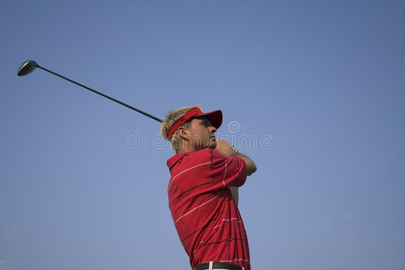 Golfer watching his ball after a great shot. Golfer watching his ball after a great shot