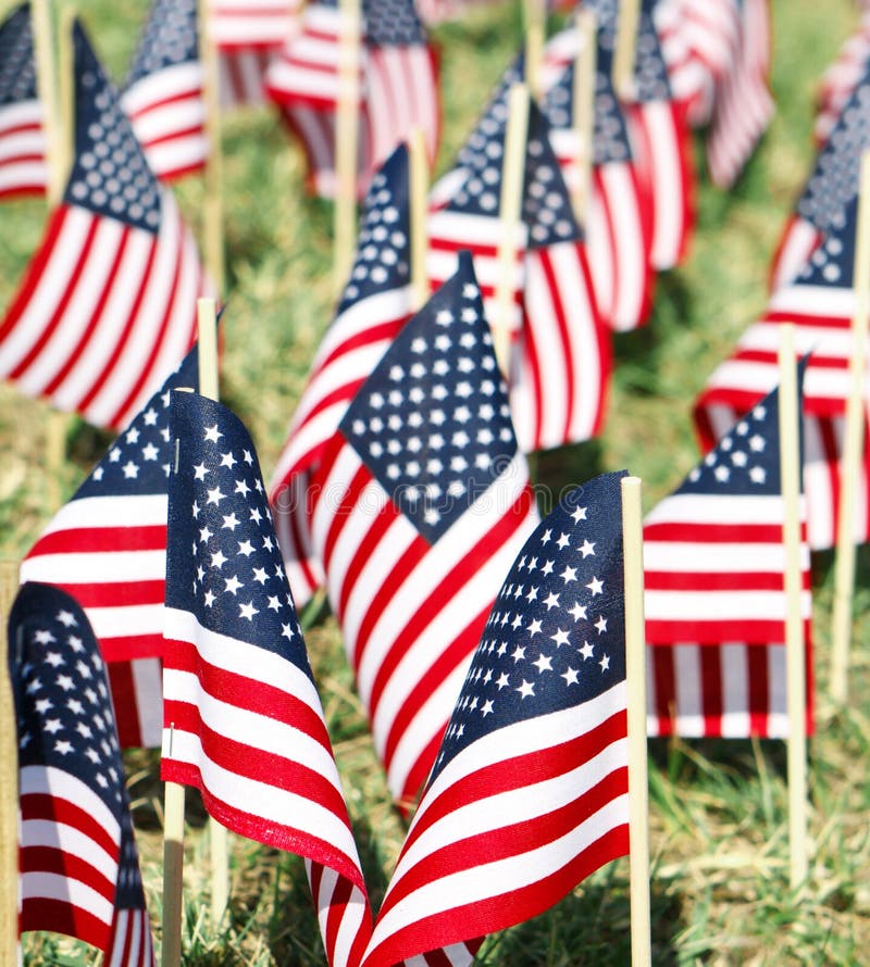 A very shallow DOF shot of a large partiotic display of American Flags stuck into the ground. A very shallow DOF shot of a large partiotic display of American Flags stuck into the ground.