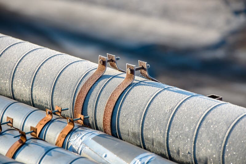 Ground heating pipes in winter-close-up. Frost on the heat pipe