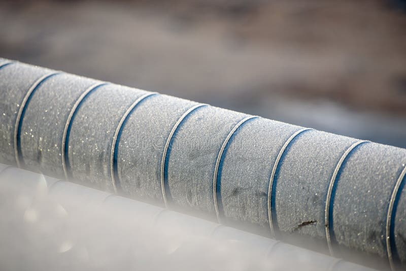 Ground heating pipes in winter-close-up. Frost on the heat pipe.