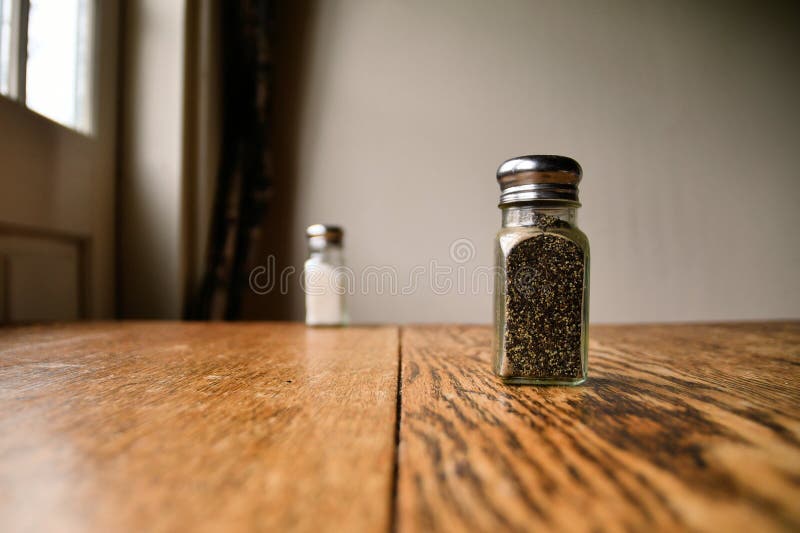 Pepper Shaker with Blurred Salt Shaker in Background Stock Photo - Image of  bottle, seasoning: 230452622