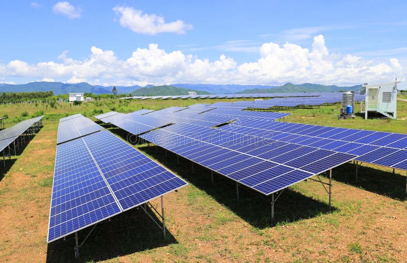 On Ground Solar Farm under Blue and Cloudy Sky Mountain Background royalty free stock photos On Ground Solar Farm under Blue and Cloudy Sky Mountain Background royalty free stock photos