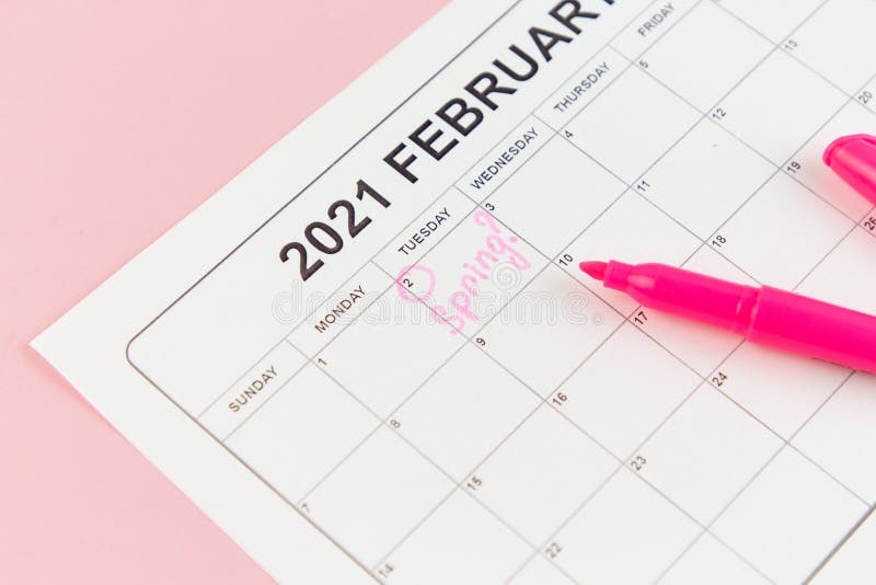 Groundhog Day concept. The word Spring is written on the calendar on the date 02 February. Pink background