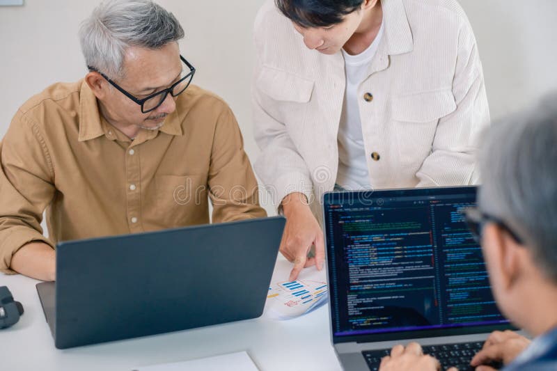 Group of asian senior in a collaborative software development analyzing flowcharts during a bootcamp training royalty free stock photos
