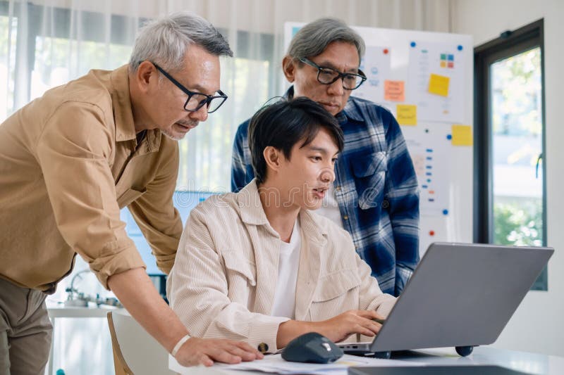 Group of asian senior in a collaborative software development analyzing flowcharts during a bootcamp training royalty free stock photos