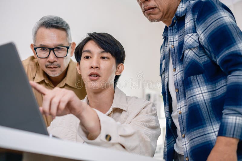Group of asian senior in a collaborative software development analyzing flowcharts during a bootcamp training royalty free stock photography