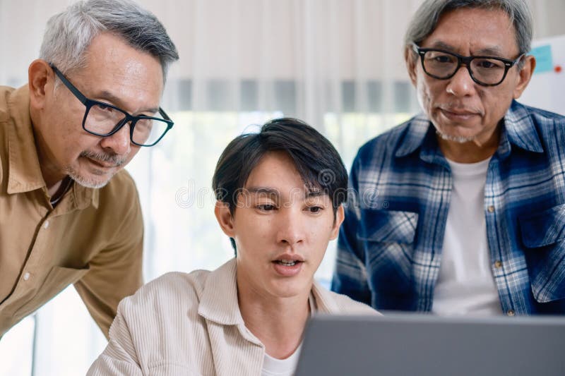 Group of asian senior in a collaborative software development analyzing flowcharts during a bootcamp training royalty free stock photos