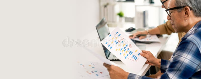Group of asian senior in a collaborative software development analyzing flowcharts during a bootcamp training royalty free stock photos
