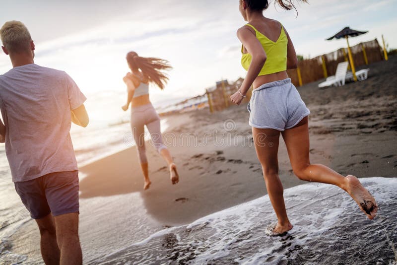 Group Of Athletes Running On Ocean Front Friends In Sportswear 