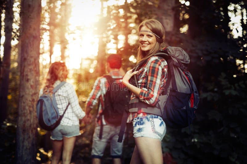 Group of Backpacking Hikers Going for Forest Trekking Stock Image