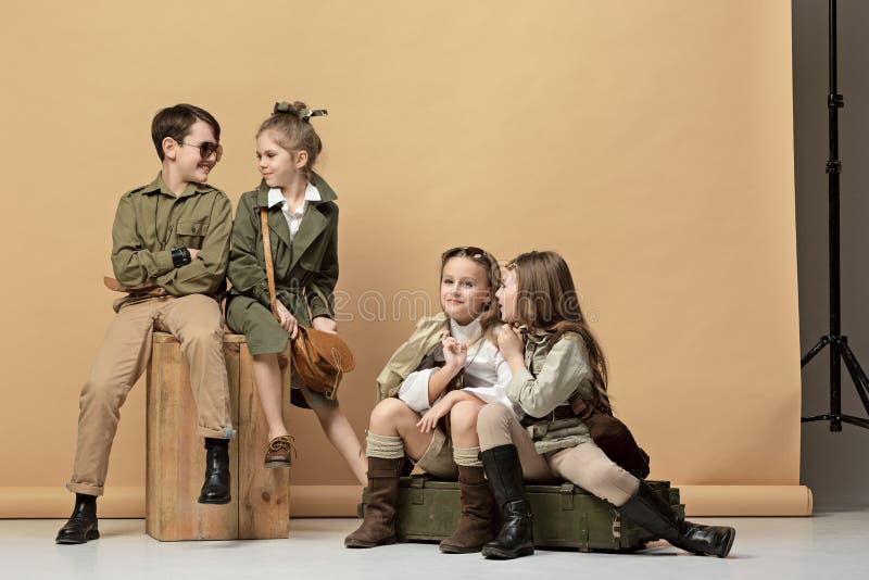 The group of beautiful girls and boys on a pastel background