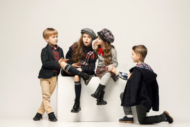 The group of beautiful girls and boys on a pastel background