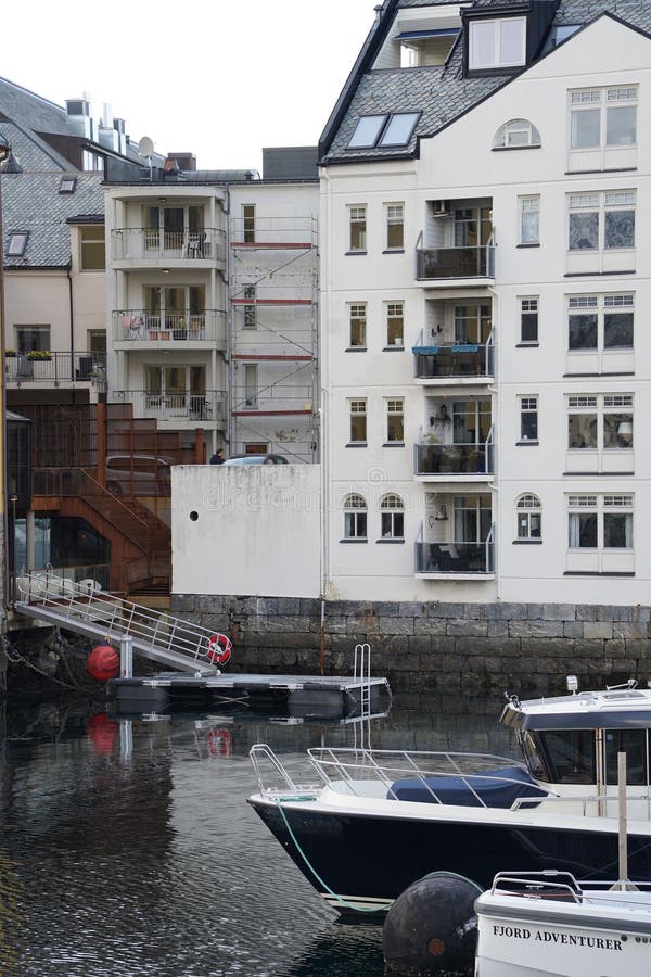 Group of Boats Docked in the Water on a Dock Editorial Stock Photo