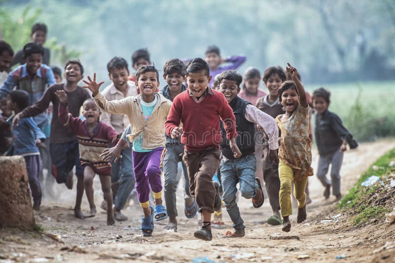 Group of boisterous Indian children running for photograph in Agra, Uttar Pradesh, India royalty free stock photos