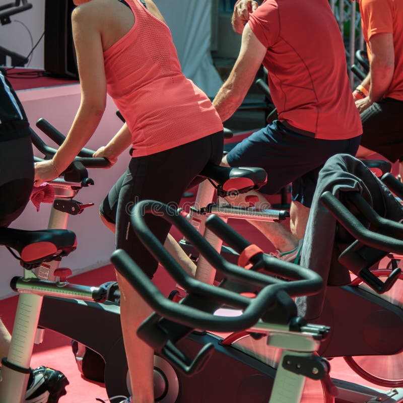 Group of Boys and Girls at Gym Workout with Spinning Bikes Stock Photo