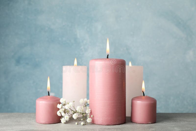 Group of burning candles and flower against background, close up royalty free stock photo