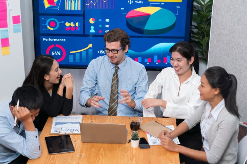 Group of business analyst team analyzing financial data report. Meticulous. Finance data analysis chart and graph dashboard show on TV screen in meeting room for strategic marketing planning.