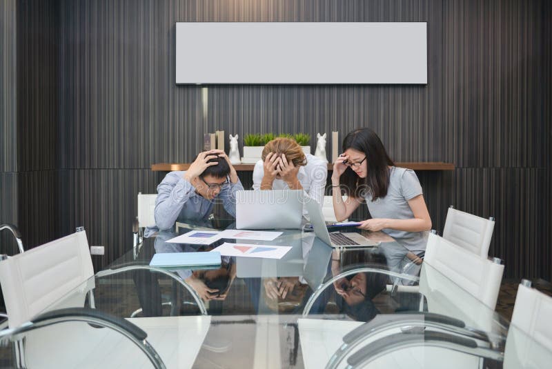 Group of business people depressed in a meeting room, sharing th stock images Group of business people depressed in a meeting room, sharing th stock images