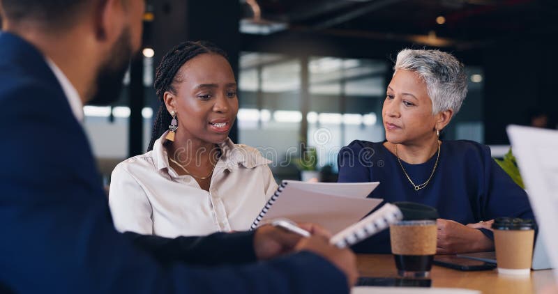 Group, business people and discussion with paperwork in cafe for brainstorming or problem solving. Meeting, team and royalty free stock images