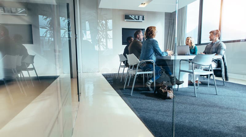 Group of business people having discussion in conference room stock image