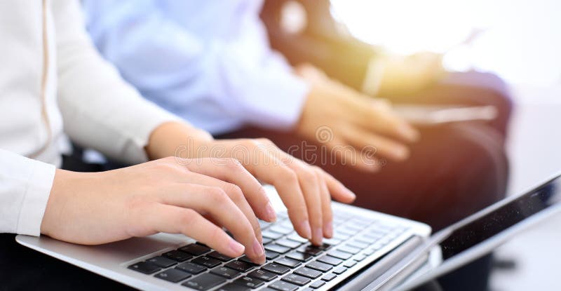 Group of business people sitting in office waiting for job interview, close-up. Hands of woman working on laptop royalty free stock photography Group of business people sitting in office waiting for job interview, close-up. Hands of woman working on laptop royalty free stock photography