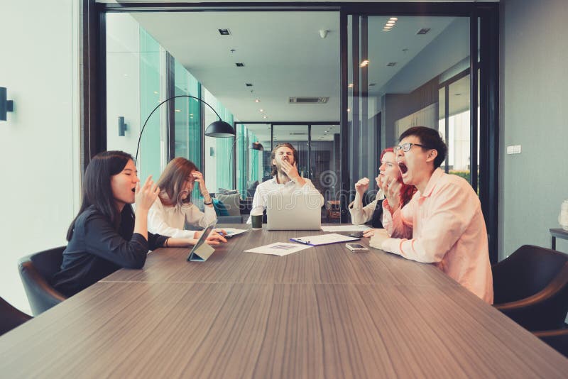 Group of business people yawning in a meeting room, sharing their ideas, Multi ethnic royalty free stock images Group of business people yawning in a meeting room, sharing their ideas, Multi ethnic royalty free stock images