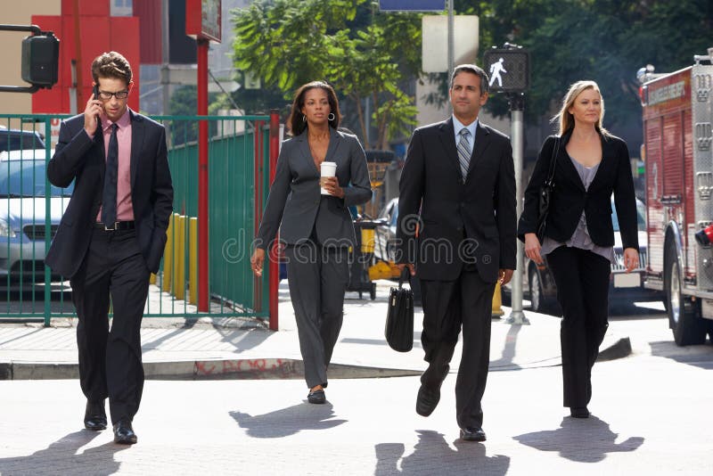 Group Of Businesspeople Crossing Street