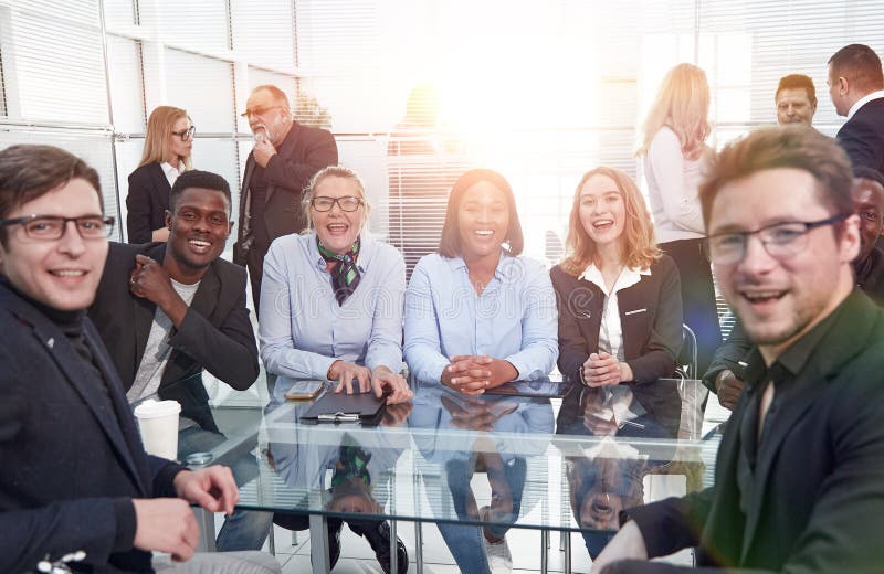Group of Businesspeople Meeting Around Table in Office Stock Image