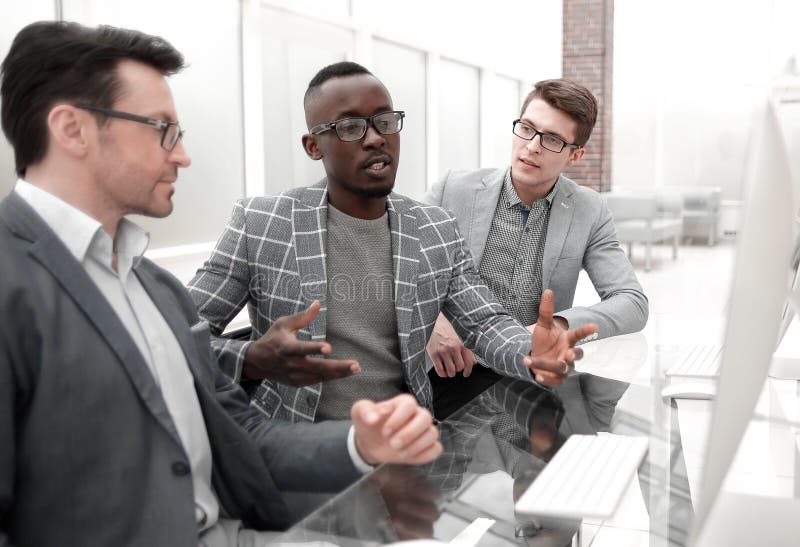 Group of Casually Dressed Businesspeople Discussing Ideas in the Office ...