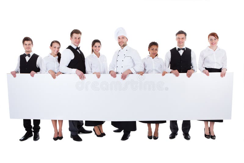 Group of catering staff holding a blank banner royalty free stock images Group of catering staff holding a blank banner royalty free stock images