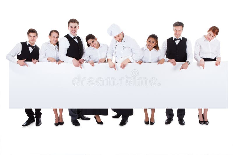 Group of catering staff holding a blank banner stock image Group of catering staff holding a blank banner stock image