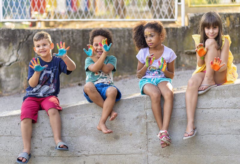 Group of cheerful multicultural children playing together stock images