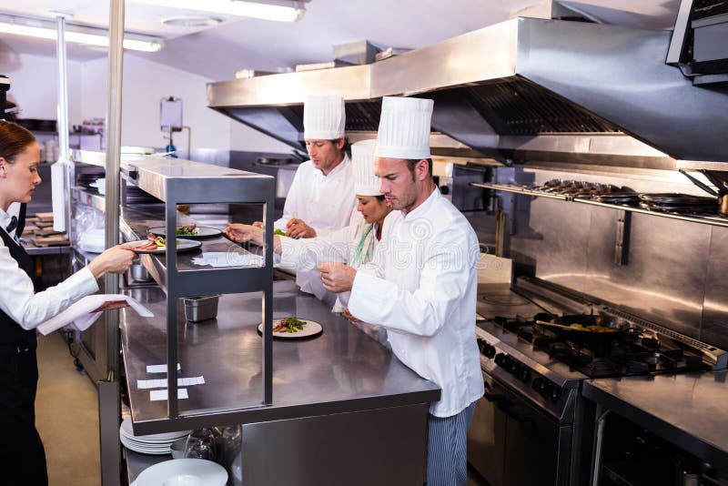 Group of Chef Preparing Food in Commercial Kitchen Stock Photo - Image ...