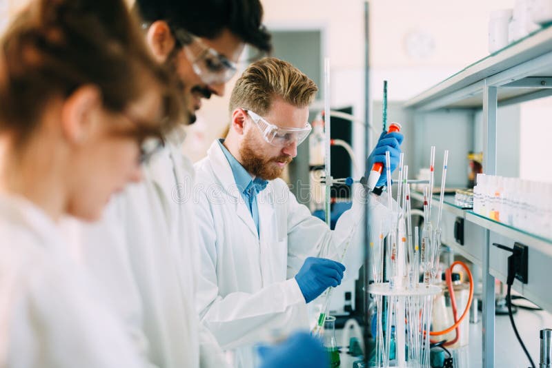 Group of chemistry students working in laboratory stock photos